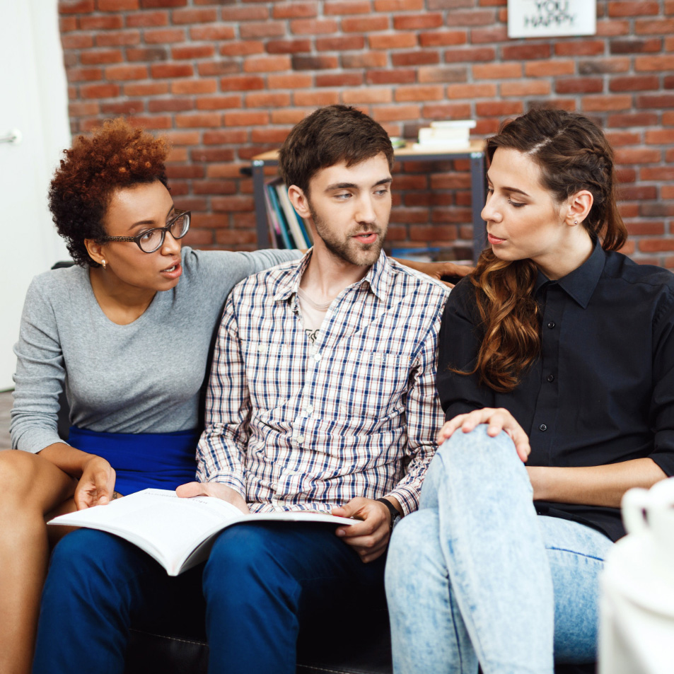 diverse group of adults looking at program guide